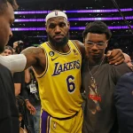 LeBron James made history on Tuesday night. In his long-awaited regular season debut on Nov. 18, the 40-year-old superstar officially became the first player in NBA history to play 23 seasons, breaking his tie with Vince Carter. And while his return energized the arena, the Los Angeles Lakers found themselves in a surprising back-and-forth battle before finally pulling away to beat the Utah Jazz 140-126. Utah came out firing, pushing the pace and dropping 71 points in the first half. The Lakers, meanwhile, were working LeBron back into the lineup after he missed training camp and the first 14 games with a sciatica issue. But Los Angeles locked in after halftime, exploding for 73 second-half points to take control. Here’s a full breakdown of LeBron James’ performance in his 2025-26 season debut. LeBron James’ Stats vs. the Jazz Points: 11 Field goals: 4-of-7 3-pointers: 2-of-3 Free throws: 1-of-4 Rebounds: 3 Assists: 12 Steals: 1 Blocks: 0 Turnovers: 1 Fouls: 0 Plus/minus: +1 Minutes: 30 LeBron returned with a classic playmaking performance — a double-double (11 points, 12 assists) — in 30 minutes on the floor. LeBron’s Emotional Return: “A Lot of Joy” LeBron was the last player to run out during introductions and the first to be announced before tip-off, drawing the loudest cheers from the sold-out crowd of 18,997 at Crypto.com Arena. And every flashy pass had fans roaring. Even though Luka Doncic stole the scoring spotlight with 37 points and 10 assists, the night still belonged to LeBron’s comeback. “It was just fun to be out there with the guys,” LeBron said. “It’s been rough mentally… I’ve never missed the beginning of a basketball season since I was nine years old.” By the time he checked out midway through the fourth quarter, he had pushed the Lakers to a 20-9 run and helped them build their biggest lead of the night. Coach JJ Redick praised his performance: “He played with the right spirit. Very unselfish. Didn’t force anything… Really good to have him back.” How LeBron Changed the Game LeBron’s return instantly boosted the Lakers’ offense: Austin Reaves scored 26 points on efficient shooting. Deandre Ayton finished with 20 points and 14 rebounds, crediting LeBron’s passes for several easy buckets. Jake LaRavia added 15 points, also benefiting from LeBron’s playmaking. “I’m sure with some of these passes he didn’t even see me cutting,” Ayton joked. “He’s making your life easy.” The Lakers ended up with their highest-scoring game of the season and shot a season-best 59.5% from the field. Reaves summed it up perfectly: “We have two of the best passers to ever touch a basketball… the game should be pretty easy.” Jazz Put Up a Fight Utah didn’t go quietly: Keyonte George: 34 points, 7 assists Lauri Markkanen: 31 points The Jazz led 36-27 after the first quarter and 71-67 at halftime. But the Lakers tightened their defense, holding Utah to just 36 points in the next 18 minutes, completely flipping the momentum. Milestones for LeBron Even with a modest scoring night, LeBron reached two major marks: His two early 3-pointers moved him past Reggie Miller to 6th all-time in NBA 3-pointers made. His third-quarter layup extended his record streak of double-digit scoring games to 1,293, a run that started in January 2007. What’s Next for the Lakers? After the win, the Lakers move to 11-4 on the season and now get a short break. Their next game? A rematch with the Jazz on Sunday in Salt Lake City. LeBron says the rhythm will come: “My wind was a little shaky… but everything tonight was as expected. I was happy I was able to keep up with the guys.” If Tuesday was any indication, LeBron’s 23rd season might still have plenty of magic left.