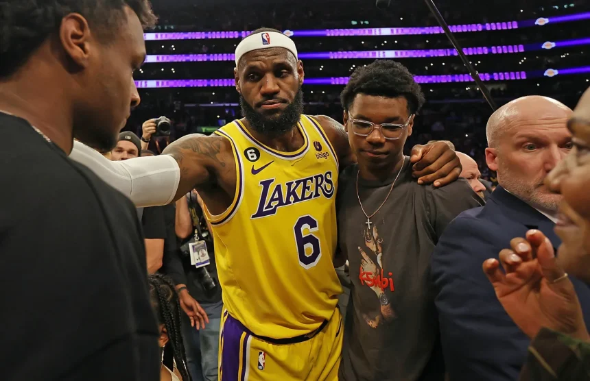 LeBron James made history on Tuesday night. In his long-awaited regular season debut on Nov. 18, the 40-year-old superstar officially became the first player in NBA history to play 23 seasons, breaking his tie with Vince Carter. And while his return energized the arena, the Los Angeles Lakers found themselves in a surprising back-and-forth battle before finally pulling away to beat the Utah Jazz 140-126. Utah came out firing, pushing the pace and dropping 71 points in the first half. The Lakers, meanwhile, were working LeBron back into the lineup after he missed training camp and the first 14 games with a sciatica issue. But Los Angeles locked in after halftime, exploding for 73 second-half points to take control. Here’s a full breakdown of LeBron James’ performance in his 2025-26 season debut. LeBron James’ Stats vs. the Jazz Points: 11 Field goals: 4-of-7 3-pointers: 2-of-3 Free throws: 1-of-4 Rebounds: 3 Assists: 12 Steals: 1 Blocks: 0 Turnovers: 1 Fouls: 0 Plus/minus: +1 Minutes: 30 LeBron returned with a classic playmaking performance — a double-double (11 points, 12 assists) — in 30 minutes on the floor. LeBron’s Emotional Return: “A Lot of Joy” LeBron was the last player to run out during introductions and the first to be announced before tip-off, drawing the loudest cheers from the sold-out crowd of 18,997 at Crypto.com Arena. And every flashy pass had fans roaring. Even though Luka Doncic stole the scoring spotlight with 37 points and 10 assists, the night still belonged to LeBron’s comeback. “It was just fun to be out there with the guys,” LeBron said. “It’s been rough mentally… I’ve never missed the beginning of a basketball season since I was nine years old.” By the time he checked out midway through the fourth quarter, he had pushed the Lakers to a 20-9 run and helped them build their biggest lead of the night. Coach JJ Redick praised his performance: “He played with the right spirit. Very unselfish. Didn’t force anything… Really good to have him back.” How LeBron Changed the Game LeBron’s return instantly boosted the Lakers’ offense: Austin Reaves scored 26 points on efficient shooting. Deandre Ayton finished with 20 points and 14 rebounds, crediting LeBron’s passes for several easy buckets. Jake LaRavia added 15 points, also benefiting from LeBron’s playmaking. “I’m sure with some of these passes he didn’t even see me cutting,” Ayton joked. “He’s making your life easy.” The Lakers ended up with their highest-scoring game of the season and shot a season-best 59.5% from the field. Reaves summed it up perfectly: “We have two of the best passers to ever touch a basketball… the game should be pretty easy.” Jazz Put Up a Fight Utah didn’t go quietly: Keyonte George: 34 points, 7 assists Lauri Markkanen: 31 points The Jazz led 36-27 after the first quarter and 71-67 at halftime. But the Lakers tightened their defense, holding Utah to just 36 points in the next 18 minutes, completely flipping the momentum. Milestones for LeBron Even with a modest scoring night, LeBron reached two major marks: His two early 3-pointers moved him past Reggie Miller to 6th all-time in NBA 3-pointers made. His third-quarter layup extended his record streak of double-digit scoring games to 1,293, a run that started in January 2007. What’s Next for the Lakers? After the win, the Lakers move to 11-4 on the season and now get a short break. Their next game? A rematch with the Jazz on Sunday in Salt Lake City. LeBron says the rhythm will come: “My wind was a little shaky… but everything tonight was as expected. I was happy I was able to keep up with the guys.” If Tuesday was any indication, LeBron’s 23rd season might still have plenty of magic left.