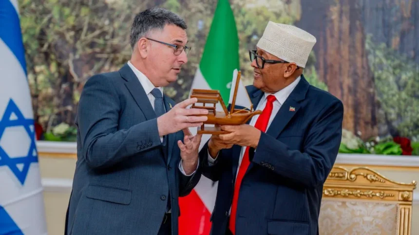 Israel’s foreign minister has met with Somaliland’s president during a historic visit to the breakaway region, marking the first official trip since Israel recognised Somaliland as an independent state last month. Gideon Saar held talks with President Abdirahman Mohamed Abdullahi, saying Israel was committed to advancing relations with Somaliland “with momentum.” Abdullahi described the visit as a “big day” for the region. Israel’s recognition of Somaliland was controversial, as Somalia considers Somaliland part of its sovereign territory and has strongly opposed the move. Somalia condemned Saar’s visit as “unacceptable interference” in its internal affairs. Posting on X, Saar said discussions covered the “entirety of our relations” and defended Israel’s decision to recognise Somaliland, stating it was not made “against anyone.” “Only Israel will determine for itself who it recognises,” Saar said. International Reaction Somaliland declared independence from Somalia in 1991 following the collapse of the government of former dictator Siad Barre, but until now had not been recognised by any country. Israel’s decision prompted international backlash, including criticism from China, Turkey, and the African Union, while the European Union reiterated its support for Somalia’s territorial integrity. The move also led to an emergency meeting of the UN Security Council. The United States defended Israel, accusing critics of applying double standards. Somaliland hopes Israel’s recognition will lead to broader international acceptance. However, India recently dismissed claims circulating online that it plans to recognise Somaliland, calling them false. Expanding Cooperation In a statement, President Abdullahi praised Israel’s recognition as a “courageous decision” and said Somaliland would cooperate with Israel in areas of strategic interest. Israel has pledged collaboration in agriculture, healthcare, technology, and economic development. Saar said Abdullahi had accepted an invitation from Israeli Prime Minister Benjamin Netanyahu to visit Israel, though Somaliland’s presidency has not confirmed this. Abdullahi has also said Somaliland would join the Abraham Accords, the 2020 U.S.-brokered agreements that normalised relations between Israel and several Arab states. Strategic Implications Analysts say Israel’s move reflects broader strategic interests in the Red Sea region, including security considerations. “Israel requires allies in the Red Sea region for many strategic reasons,” Israel’s Institute for National Security Studies said in a recent analysis, citing potential future conflict scenarios involving Iran-backed Houthi forces in Yemen. Israel’s recognition of Somaliland marks a significant geopolitical shift, with long-term implications for regional diplomacy and international recognition efforts.